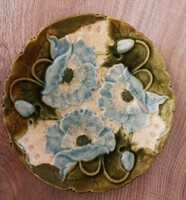 A majolica plate with poppy flowers