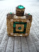 Small perfume bottle with an old openwork pattern filled with stones