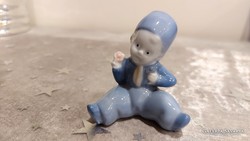 A charming little figure in a porcelain blue dress.