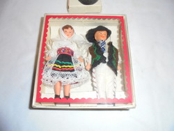 Boy and girl doll in national clothes in a gift box