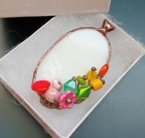 Richly visual glass pendant on white glass with colorful beads