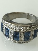 Stainless steel ring with square-cut sapphire-colored crystals and many small colorless crystals