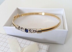 Nice 14 carat solid bangle with stones
