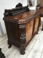 A carved sideboard with lion legs.