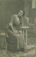 Circa 1920 - middle-class, young woman with flowers. Studio recording, photo sheet.