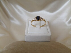 Gold ring with blue sapphire and glasses