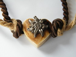 Heart-shaped necklace with a bone pendant decorated with mountain grass