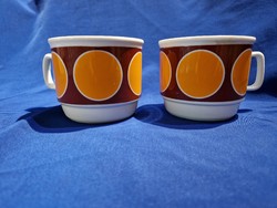 Pair of Zsolnay orange mugs with large polka dots