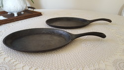 2 small oval cast iron pans.