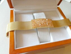 Fashionable gold colored metal bracelet