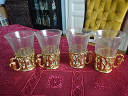 Four brandy cups in a metal holder, height 7.5 cm. He has!