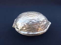 Silver-colored, nut-shaped, nutcracker