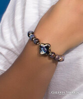 A bluish-brown bracelet with a pendant made of real porcelain pearls.