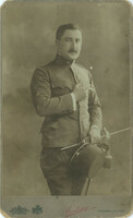 Early 1900s. Man in uniform with cigarette, studio shot.