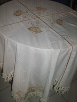 A charming tablecloth with filigree machine embroidery and fringed edges