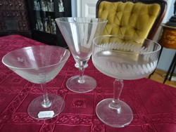 Three stemmed glasses, all different shapes and sizes.
