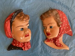 Old painted boy-girl hanging plaster heads