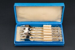Small decorative forks with cookies, in a box.