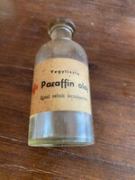 Chemically pure paraffin oil for the treatment of burn wounds. Pharmacy bottle. There is a little residual original oil in it.