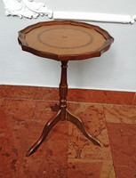 Small round table with leather upholstery