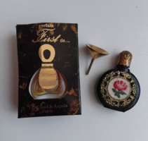 Perfume bottle adorned with dripping tapestry with a copper decorative top in a French perfume box