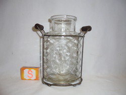 Old, convex decorative canning jar in a metal holder