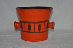 A pot in the shape of an applied art mortar