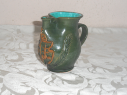 Bado green glazed ceramic jug with a coat of arms, spout