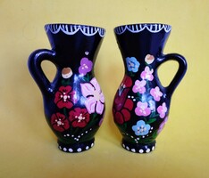 A pair of small ceramic decorative jars with folk motifs
