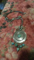 Spectacular ethno necklace of 65 cm (+ 10 cm pendant part) made of metal and minerals.