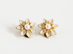 Gold colored flower ear clips, white poinsettia earrings with a pair of pearls
