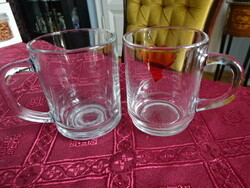 Two water glasses with handles, not the same height. He has!