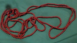 Extremely long 280 cm necklace without clasp made of shiny red glass beads.
