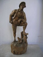 A wooden sculpture depicting a hiker