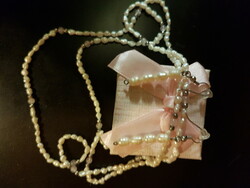 Grown from tiny seeds--- pearl necklace, including ears, garnish - with additional pearls