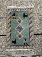 An old hand-knotted nomàd gabbeh animal rug or even an ideal wall protector