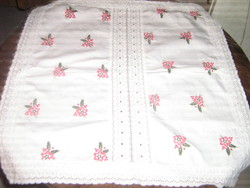 A charming floral madeira tablecloth with a lace edge and a madeira lace insert