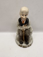 Aranyos biszkvit porcelán figura: padon pipázó apóka,12 cm. 6253