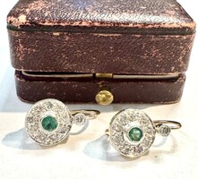 Women's earrings pair with diamonds and emeralds