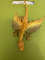 Szárnyas dinoszaurusz,sárkány. 21 cm hosszú,unokám gyűjteményéből.Sárgás színű.Új.Nem használt.