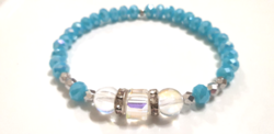 Iridescent faceted glass bracelet with polished glass ornament
