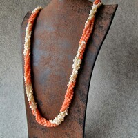 A long chain woven with angel face coral beads and natural baroque pearls