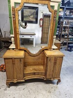 Old vanity mirror with bedside tables.