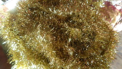 Approximately 20 meters of gold-colored boa for Christmas tree. Multiple strands tied together.