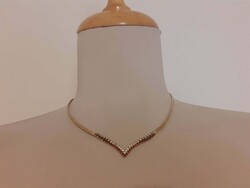 Eye-catching gold-colored necklace adorned with small crystals
