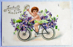 Vintage embossed greeting litho postcard - angel on bicycle with violet