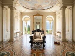 Large, intricately carved antique-style armchair