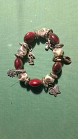 Burgundy beaded bracelet with silver-colored pendants – featuring butterfly, sun, and fish motifs