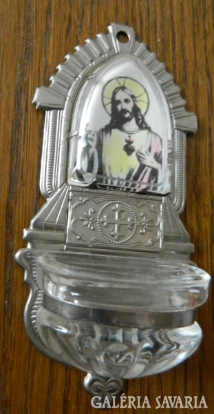 Antique glass container holding holy water with the portrait of Jesus