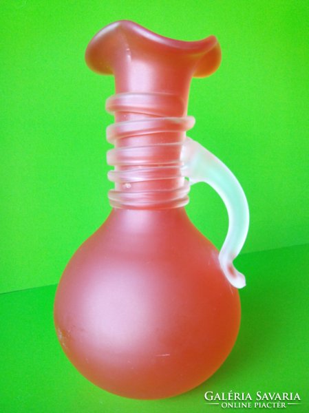 Now it's worth the price!!! A salmon-colored glass vase is a handcrafted product